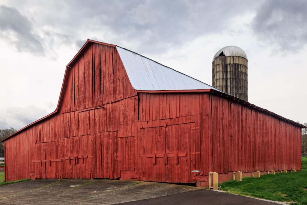 Red barn and silo in a rural Tennessee agricultural setting.